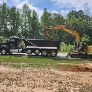 Mad Duck Construction dump truck and excavator on a site work job