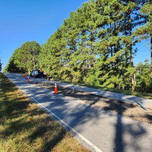 Roadway asphalt repair with traffic cones near Four Oaks, NC