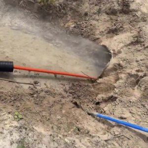 Sewer jetting truck clearing a drainage line
